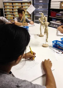 Students sketching mannequin - Sketchbook Assignment