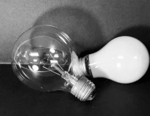 Light bulb white charcoal on black paper drawing